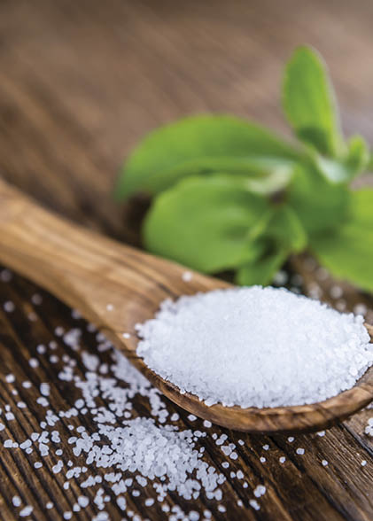 Old wooden table with Stevia Granules (selective focus; close-up shot)