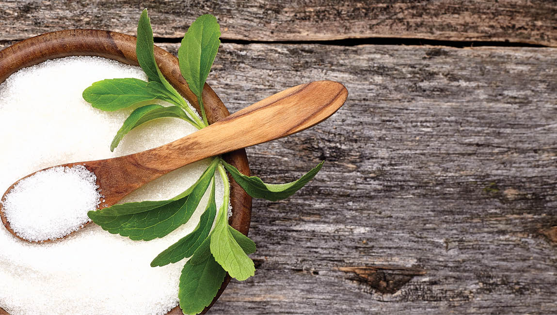 Stevia rebaudiana, sweet leaf sugar substitute in wooden bowl on wooden background.