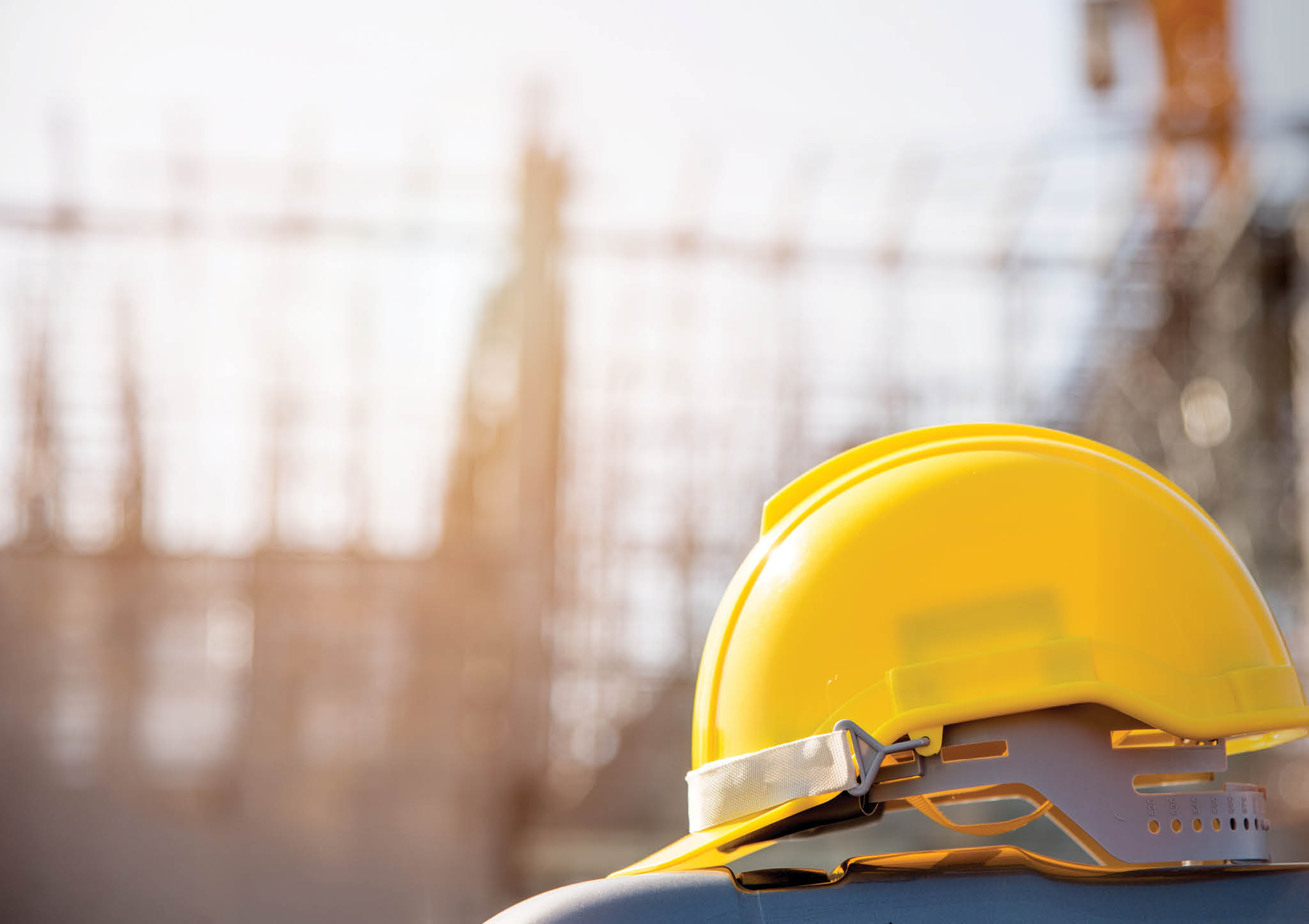 helmet in construction site and construction site worker background safety first concept