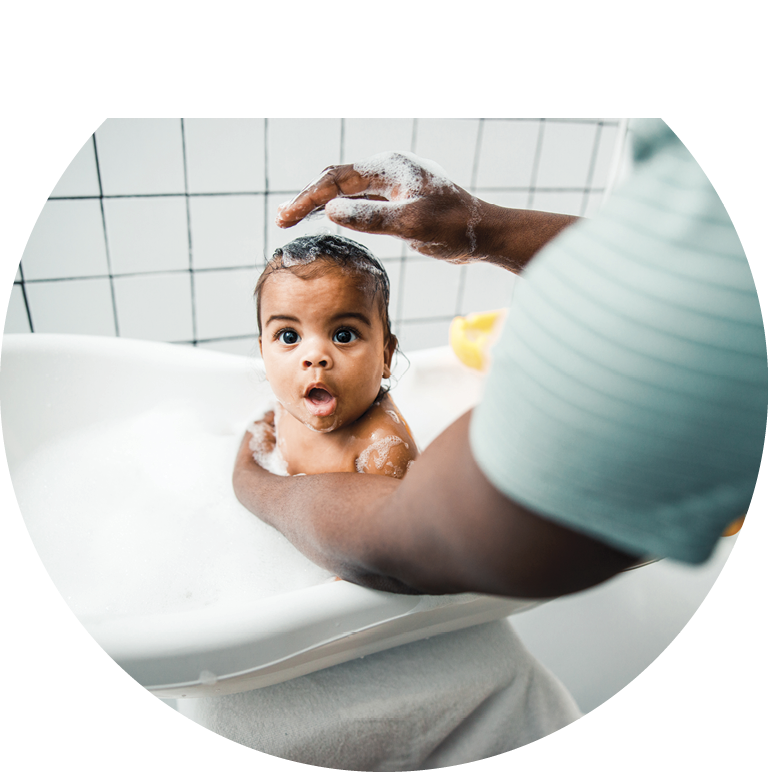 Afro American man bathing cute toddler baby in bathroom at home stock photo