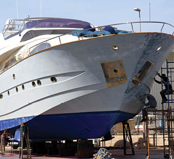 Repairs on the fiber of the hull of a yacht in the shipyard.